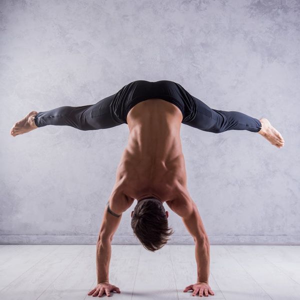 Man balancing on one leg, demonstrating core strength and stability.